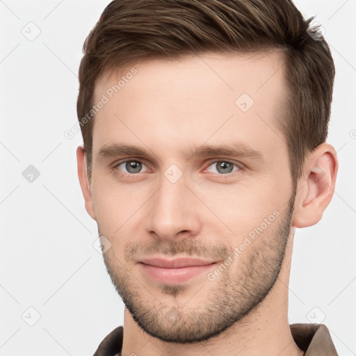 Joyful white young-adult male with short  brown hair and grey eyes