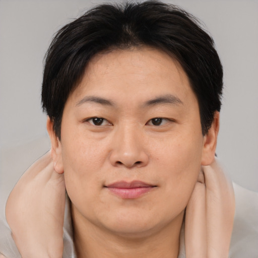 Joyful asian young-adult female with short  brown hair and brown eyes