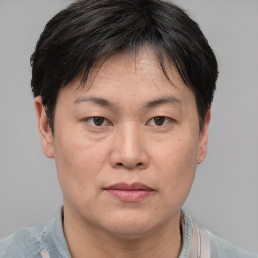Neutral asian adult female with short  brown hair and brown eyes