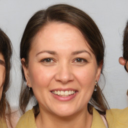 Joyful white adult female with medium  brown hair and brown eyes