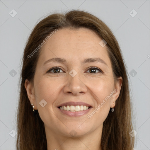 Joyful white adult female with long  brown hair and brown eyes