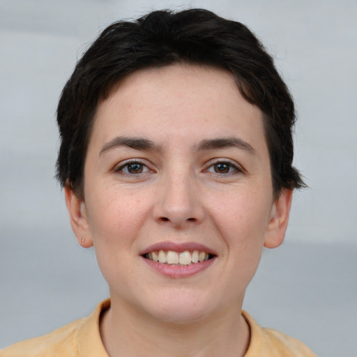 Joyful white young-adult female with short  brown hair and brown eyes