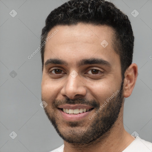 Joyful white young-adult male with short  black hair and brown eyes