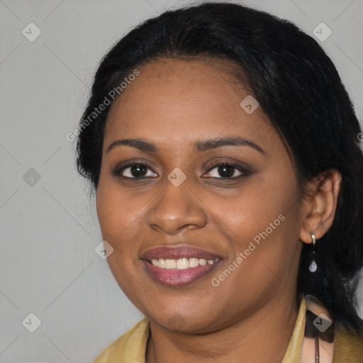 Joyful black young-adult female with long  black hair and brown eyes