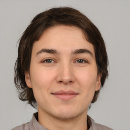 Joyful white young-adult male with medium  brown hair and brown eyes