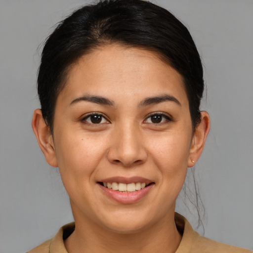 Joyful latino young-adult female with short  brown hair and brown eyes