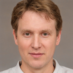 Joyful white adult male with short  brown hair and grey eyes