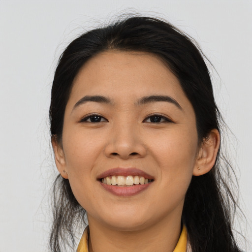 Joyful asian young-adult female with long  black hair and brown eyes