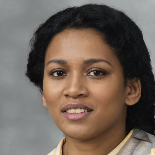 Joyful latino young-adult female with short  black hair and brown eyes