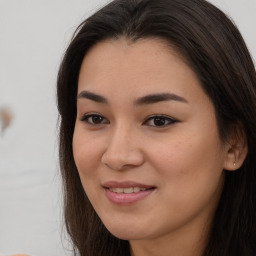 Joyful asian young-adult female with long  brown hair and brown eyes