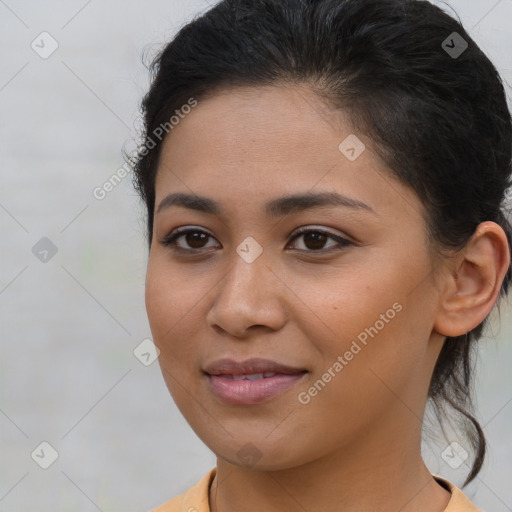 Joyful latino young-adult female with short  brown hair and brown eyes