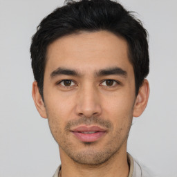 Joyful asian young-adult male with short  black hair and brown eyes