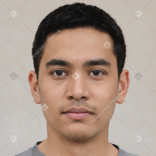 Neutral latino young-adult male with short  black hair and brown eyes