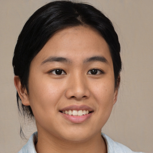 Joyful asian young-adult female with medium  black hair and brown eyes