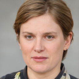 Joyful white adult female with medium  brown hair and grey eyes