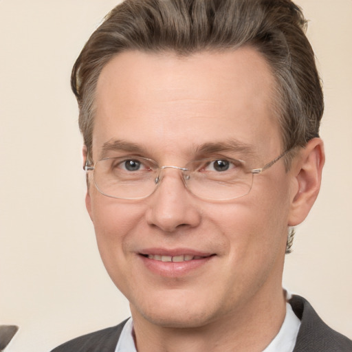 Joyful white adult male with short  brown hair and grey eyes