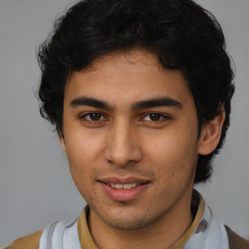 Joyful latino young-adult male with short  brown hair and brown eyes
