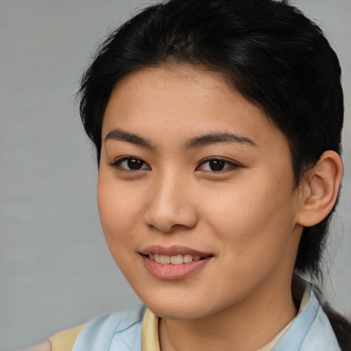Joyful latino young-adult female with medium  brown hair and brown eyes