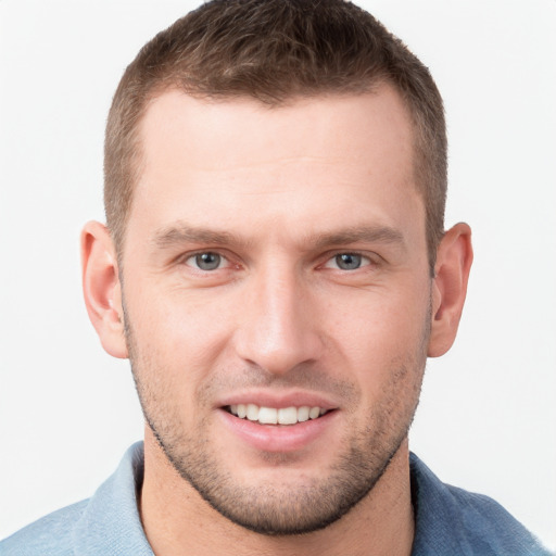 Joyful white young-adult male with short  brown hair and grey eyes