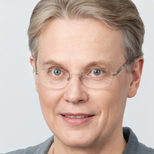 Joyful white adult male with short  brown hair and blue eyes