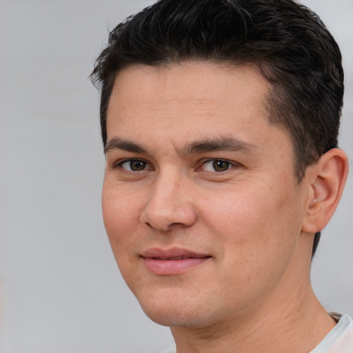 Joyful white young-adult male with short  brown hair and brown eyes