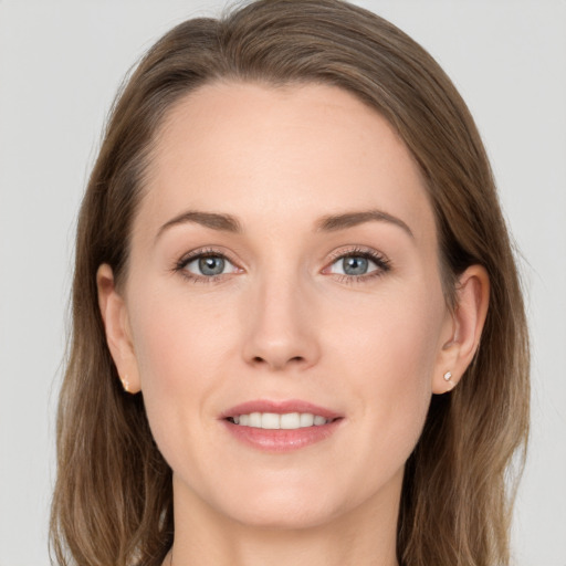 Joyful white young-adult female with long  brown hair and grey eyes