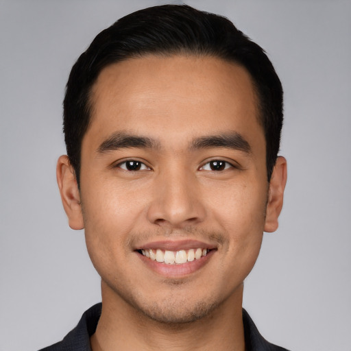 Joyful white young-adult male with short  black hair and brown eyes