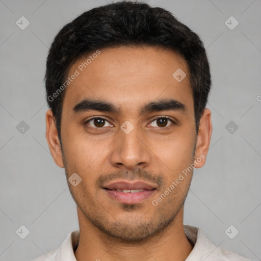 Joyful latino young-adult male with short  black hair and brown eyes