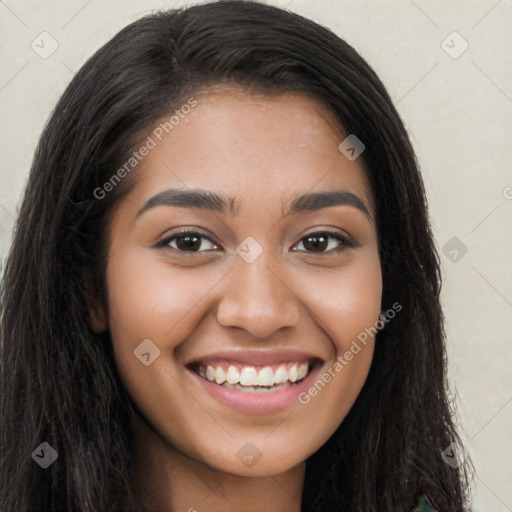 Joyful latino young-adult female with long  brown hair and brown eyes