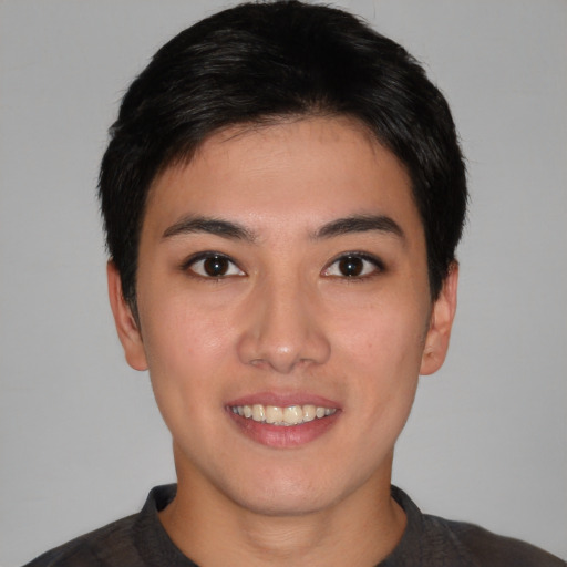 Joyful asian young-adult male with short  brown hair and brown eyes