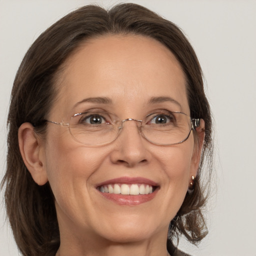 Joyful white adult female with medium  brown hair and brown eyes