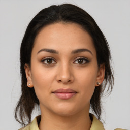 Joyful latino young-adult female with medium  brown hair and brown eyes