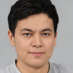 Joyful asian young-adult male with short  brown hair and brown eyes