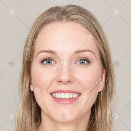 Joyful white young-adult female with long  brown hair and blue eyes