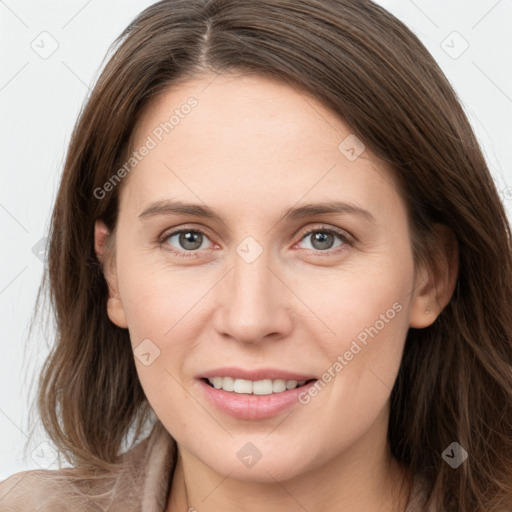 Joyful white young-adult female with long  brown hair and grey eyes