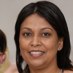 Joyful latino adult female with medium  brown hair and brown eyes