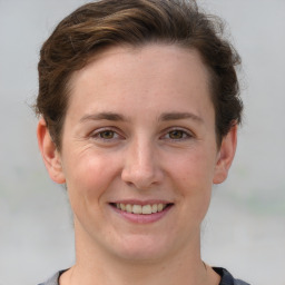 Joyful white young-adult female with short  brown hair and grey eyes