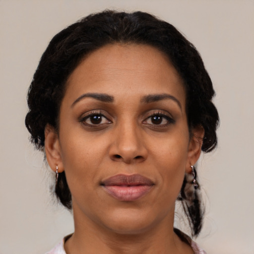 Joyful black young-adult female with medium  black hair and brown eyes