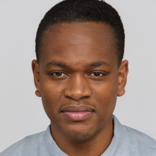 Joyful black young-adult male with short  brown hair and brown eyes