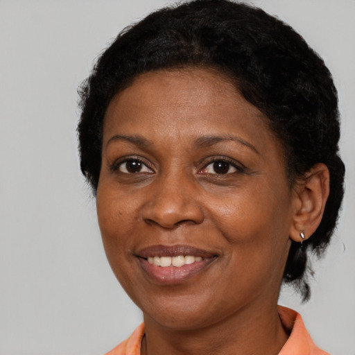 Joyful black adult female with short  black hair and brown eyes