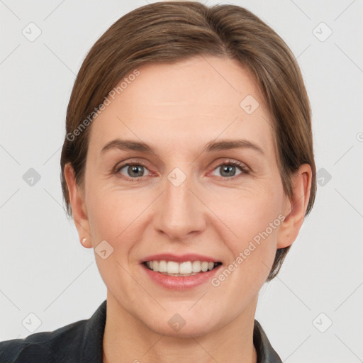 Joyful white adult female with short  brown hair and grey eyes