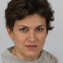 Joyful white adult female with short  brown hair and brown eyes