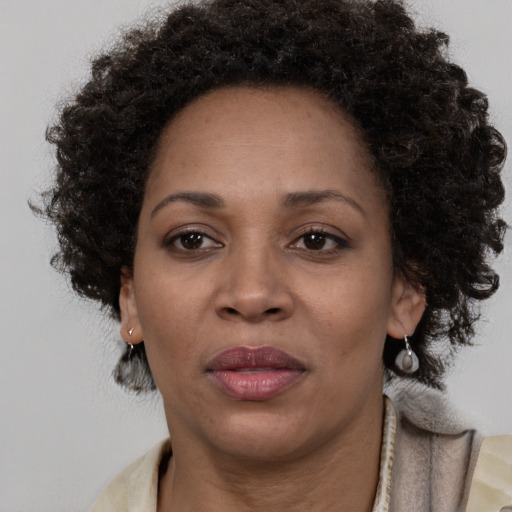 Joyful black adult female with medium  brown hair and brown eyes