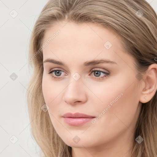 Joyful white young-adult female with long  brown hair and blue eyes