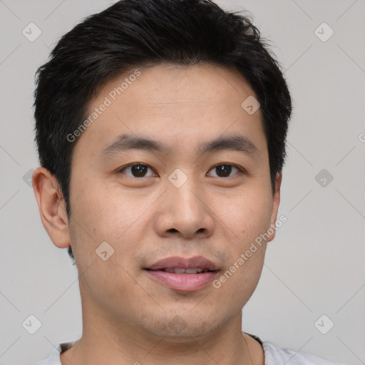 Joyful asian young-adult male with short  brown hair and brown eyes