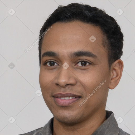 Joyful latino young-adult male with short  black hair and brown eyes