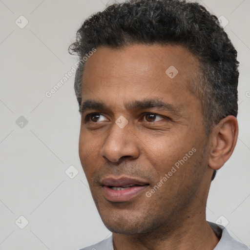 Joyful black adult male with short  black hair and brown eyes