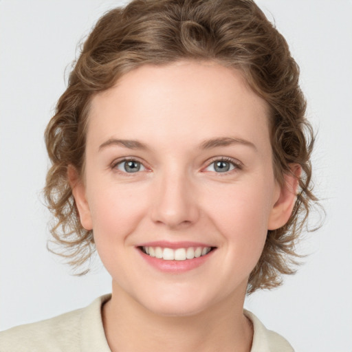 Joyful white young-adult female with medium  brown hair and blue eyes