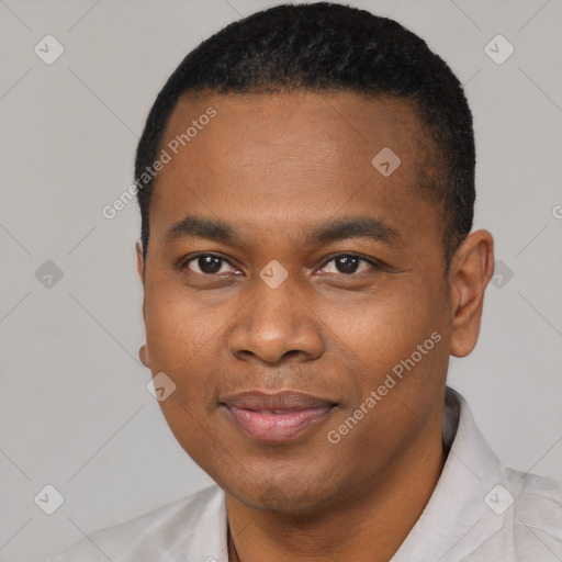 Joyful black young-adult male with short  black hair and brown eyes