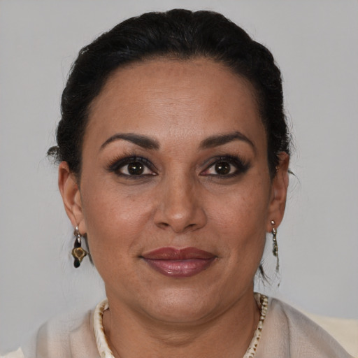Joyful latino adult female with short  brown hair and brown eyes